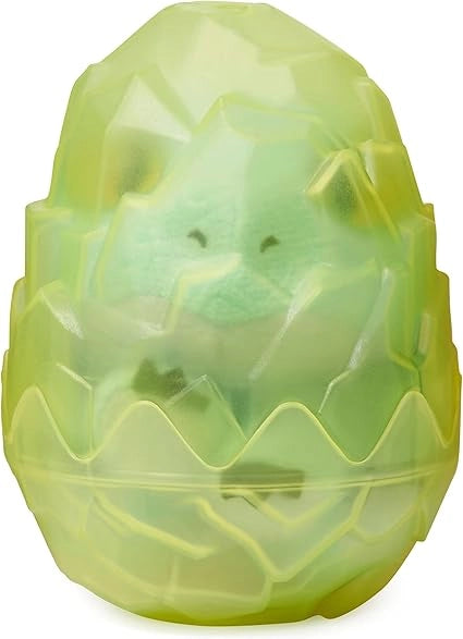 Green plastic toy resembling a dinosaur egg on a white background