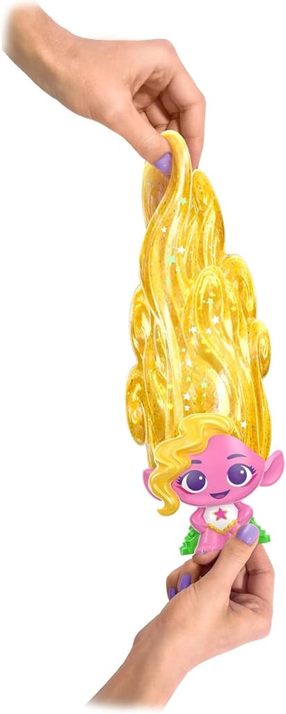 Toy figure with long yellow hair held by a hand against a neutral background
