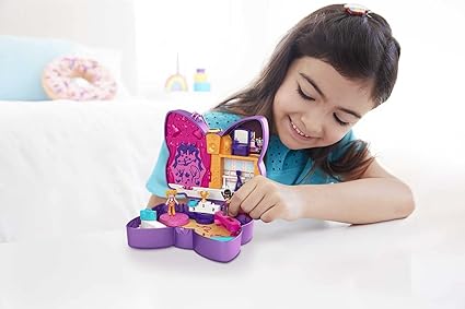 A girl is playing with polly pocket surprise dance set