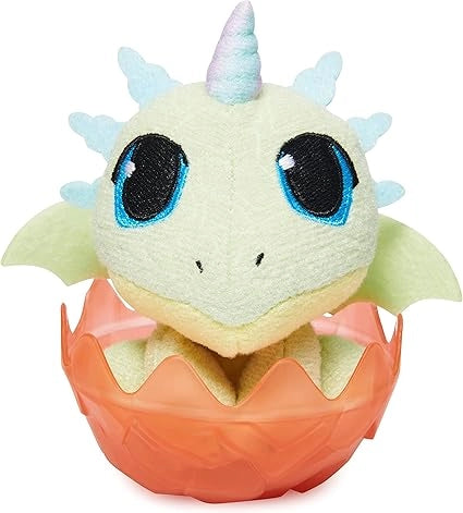 Plush toy of a yellow and blue creature with blue eyes in a peach egg on a white background