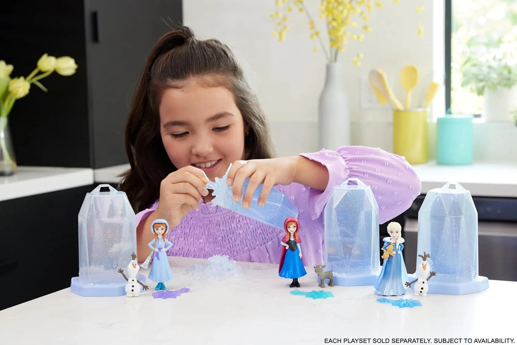 Girl playing with Disney Frozen Small Doll Ice Reveal