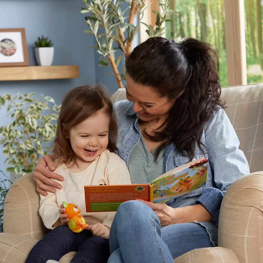 Mother is telling WiggleBug Story from Storybook to child holding WiggleBug