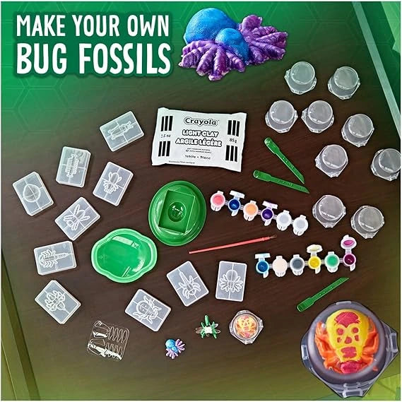 Crayola make your own bug fossils kit with molds, clay, and paint on a green background