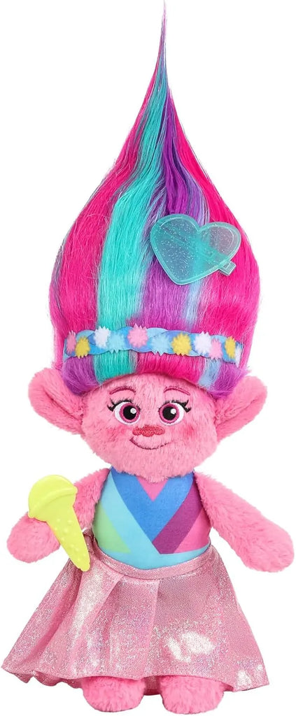 Colorful plush toy with pink hair and a heart-shaped bow on a white background