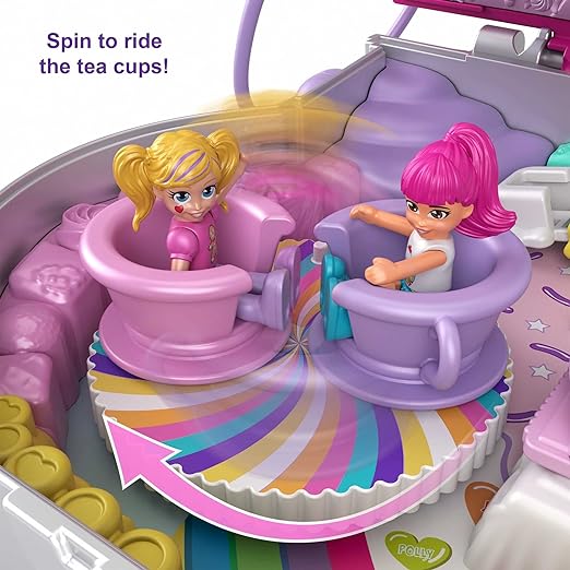 two dolls are sitting in spin to ride the tea cups of candyland adventures.