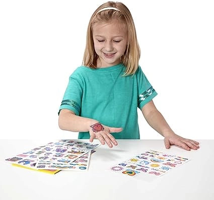Child with temporary tattoos on a white background