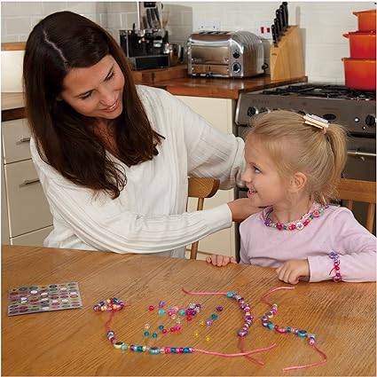 A girl and his mom making beads necklace with sparkle