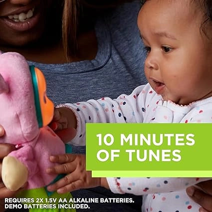 Baby interacting with a toy, held by an adult, with a '10 Minutes of Tunes' label.