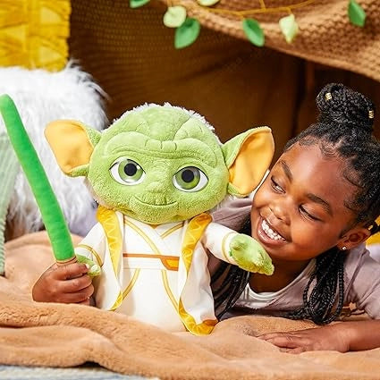 A girl is playing with Yoda Plush