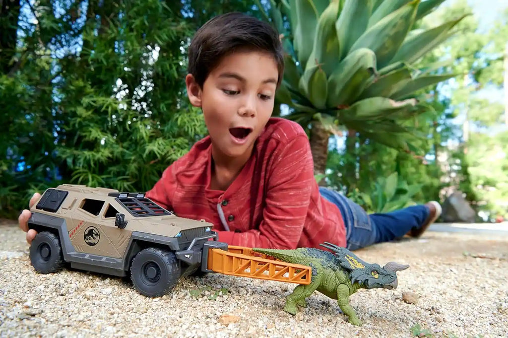 Boy is playing with Truck & Einiosaurus Dinosaur Action Figure