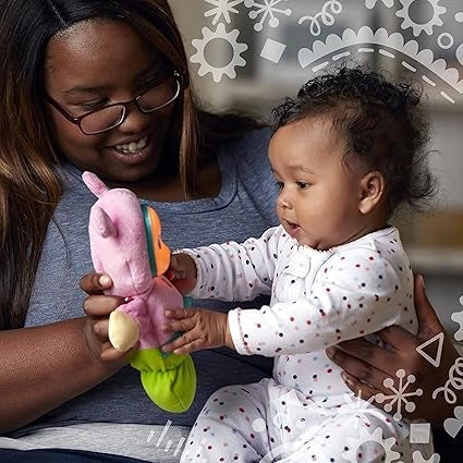 Woman holding a baby and a colorful toy, with a decorative background
