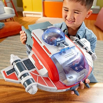 Child holding a toy spaceship in a room with colorful walls.