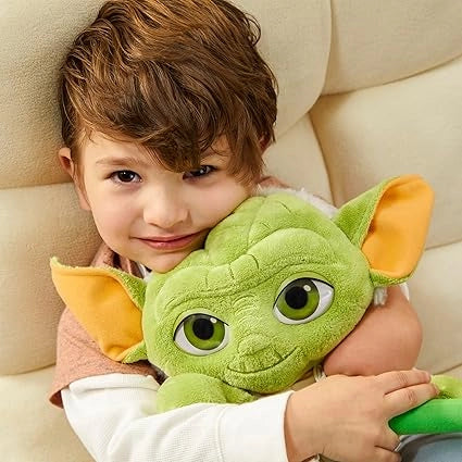 A child is hugging Star Wars Master Yoda Plush toy