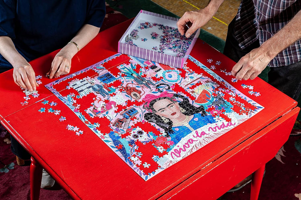 jigsaw puzzle on the table , people are making eeboo puzzle