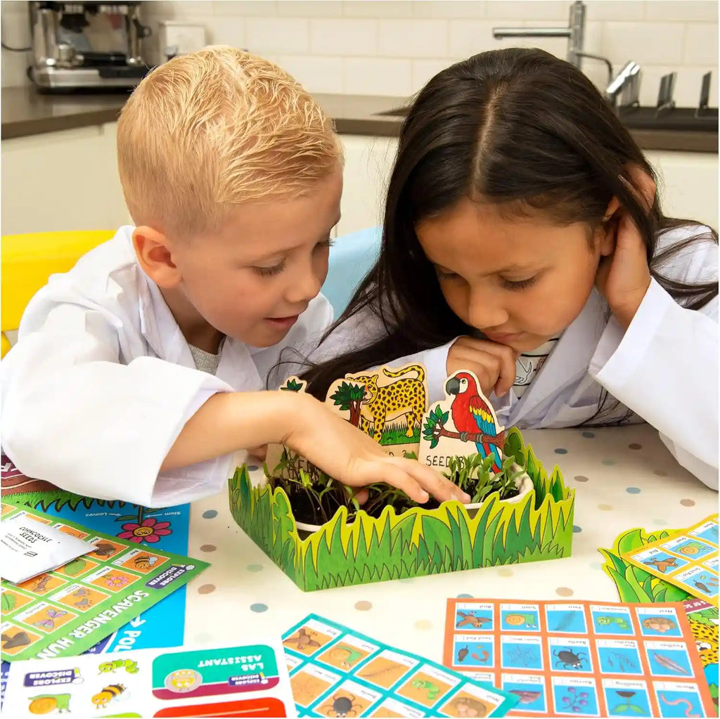 A child using the Galt Nature Lab kit to examine a leaf with a magnifying glass.