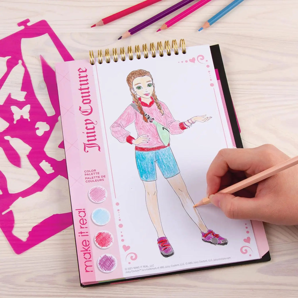 Girl using stencils to create fashion designs in the sketchbook.