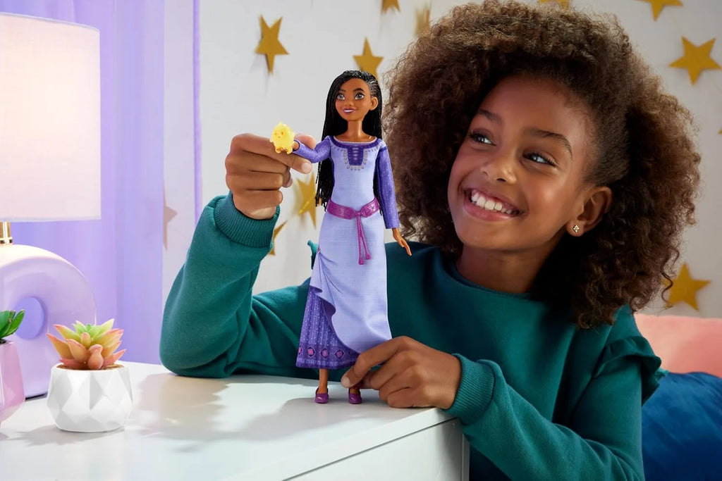 Girl playing with Mattel Disney's Wish Singing Asha of Rosas Doll with Star Figure