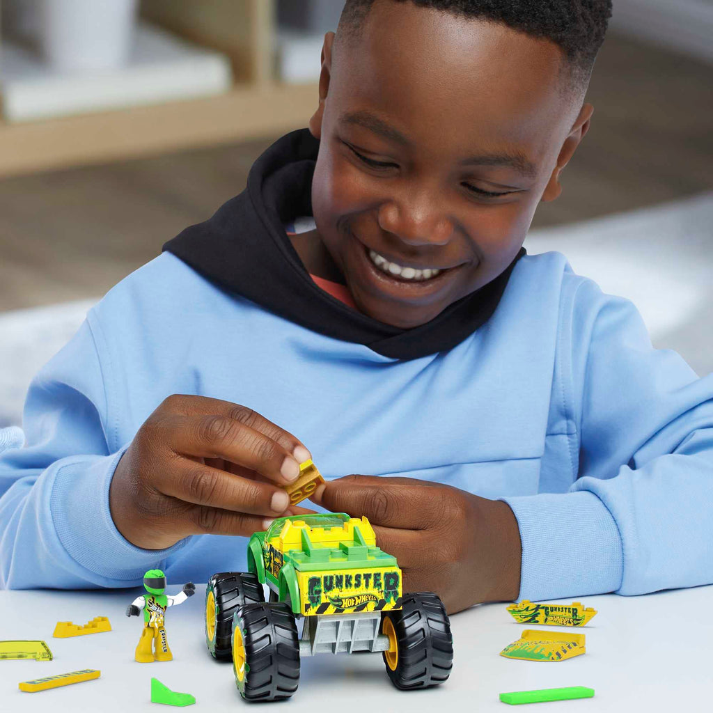 ids playing with the Gunkster monster truck, engaging in imaginative construction and play."